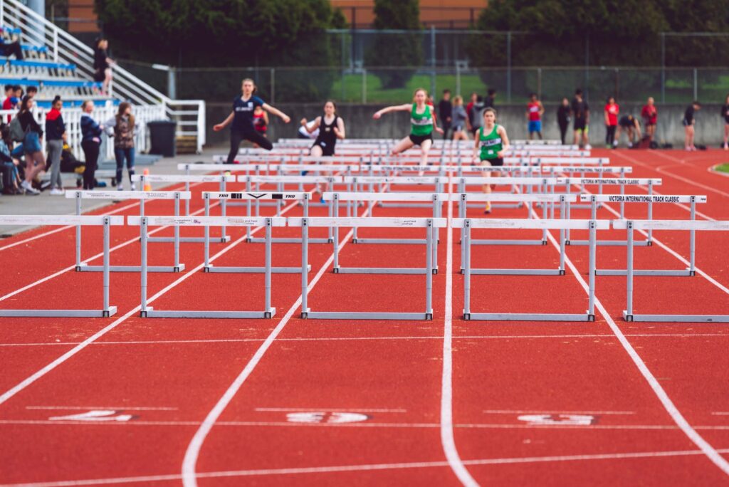 shallow focus photo of people playing track and field