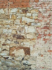 photo of a wall contains bricks and stones