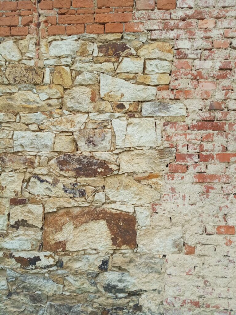 photo of a wall contains bricks and stones